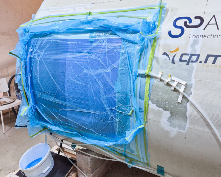 Applying glass fiber mats and performing vacuum infusion with standard resin